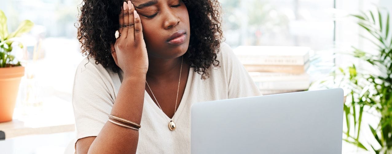 Female looking tired at desk