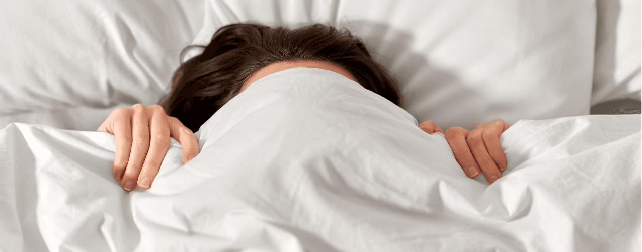 Female hiding under covers