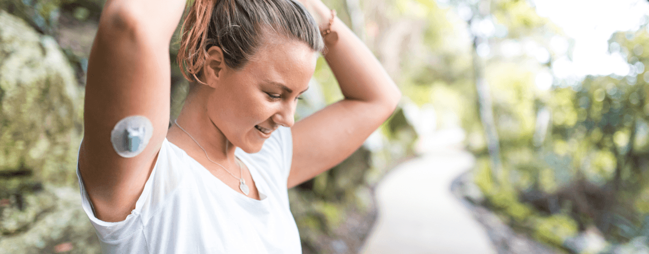 Female with diabetes device on arm