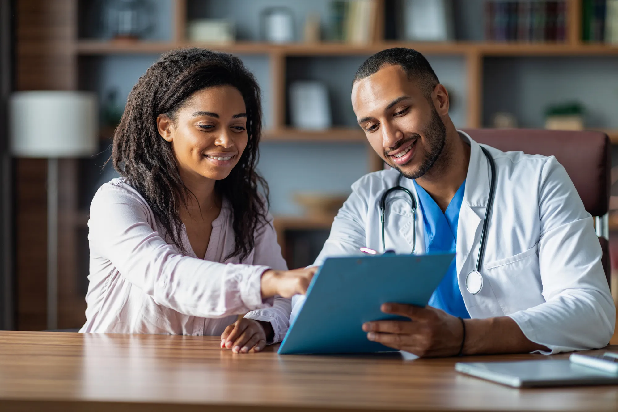 Doctor and patient looking at notepad